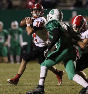 South Point quarterback Scott Lee rolls out for the pass in an Oct. 6 game at Ashbrook. MIKE HENSDILL/THE GAZETTE
