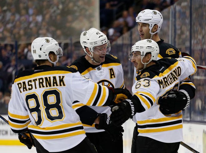 Bruins forward Brad Marchand (front right) celebrates with David Pastrnak (left), David Backes (second from left), and Zdeno Chara after scoring during the third period of Boston's 6-3 win over the Blue Jackets on Thursday night.