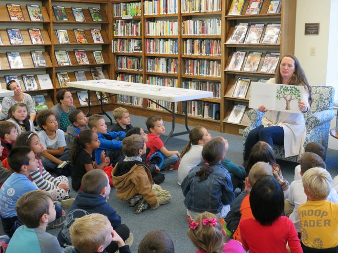 Megan Nickerson reads a book with first-grade children at the Barnstable-West Barnstable School during a program at Sturgis Library. COURTESY PHOTO BY SUSAN VAUGHN