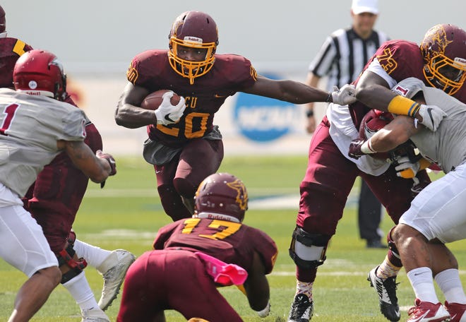 Bethune-Cookman's Tupac Isme (20) looks for running room against N.C. Central. News-Journal/NIGEL COOK