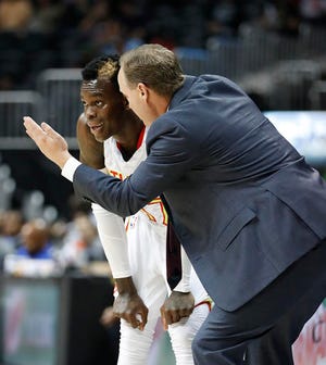 Atlanta Hawks guard Dennis Schroder (17) listens as coach Mike Budenholzer speaks during the first half of a preseason NBA basketball game against the Detroit Pistons on Thursday, Oct. 13, 2016, in Atlanta. With the departure of Jeff Teague, Schroder is expected to take over at point guard. (AP Photo/John Bazemore)