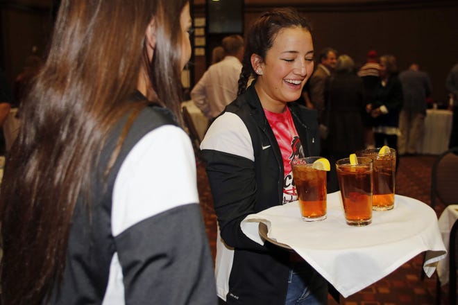 Sydney Hill, a volleyball pstudent athlete at SCC, helps serve iced tea during the Southeastern Community College's Celebrity Night fundraiser, which included a special guest appearance by Mike Jarvis, a silent auction, and a table-service dinner Thursday Oct. 13, 2016 in Burlington, IA.