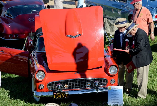 Judges Angelo Rumore, left, and Matt Cannizzaro look at a 1955 Ford Thundebird owned by Jack Edison during the 16th annual Lake Mirror Classic Auto Festival in Lakeland at last year's event.

SCOTT WHEELER/LEDGER FILE
