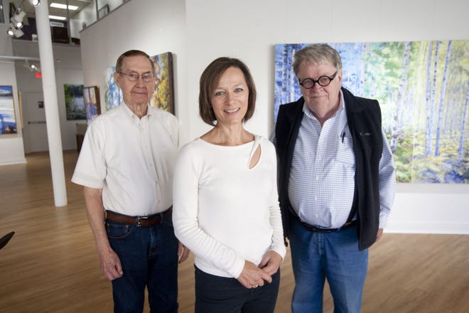 Burlington Art Center director Tammy McCoy, middle, is photographed Friday with charter member and founding member Robert McCannon, right, and permanent archives manager Jim Hunt, left, at the Art Center in downtown Burlington.