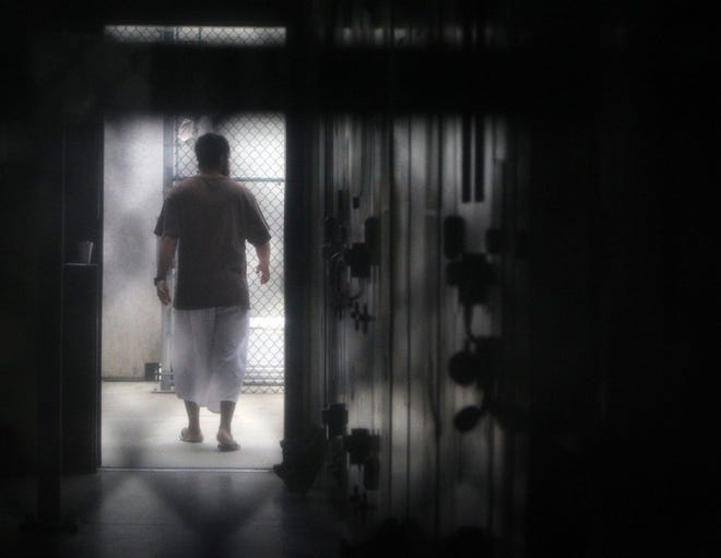 A cooperative captive walks Feb. 9 inside a communal cellblock at Camp 6 at the U.S. Navy base at Guantanamo Bay, Cuba.
