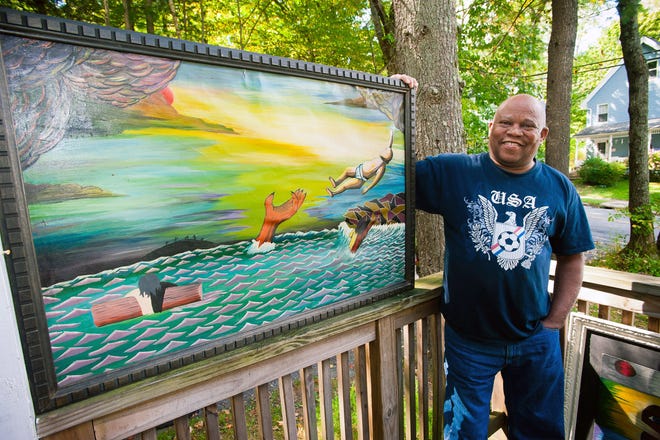 Clyde Washington of Liberty stands beside one of his paintings, entitled "Save The Baby." His works will be exhibited at the Liberty Museum and Arts Center. PHOTOS BY JOHN DESANTO/FOR THE TIMES HERALD-RECORD