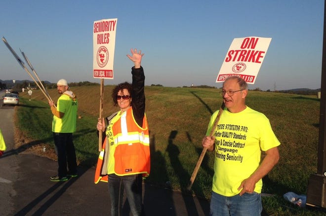 Workers hold picket signs outside the Jim Beam plant in Clermont, Ky., on Saturday, Oct. 15, 2016. More than 200 union workers walked off their jobs at Beam distilleries at Clermont and Boston in Kentucky after voting Friday to reject the latest contract offer from the world's leading bourbon producer. As the old contract expired, Beam said its contingency plans would keep operations running to maintain the flow of whiskey to distributors and consumers.