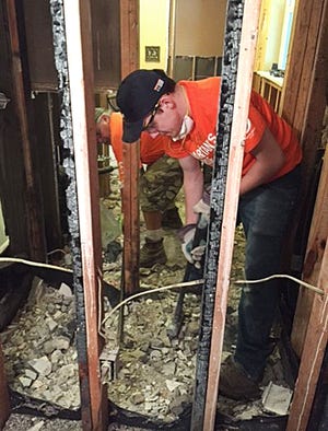 Eoghan Lowry, a member of the Hartsville Fire Co. in Warminster, works on a flood-damaged home in East Baton Rouge Parish. Lowry was one of several firefighters from Hartsville to travel to Louisiana last week to help aid the recovery efforts in areas of Louisiana devastated by floods in August.