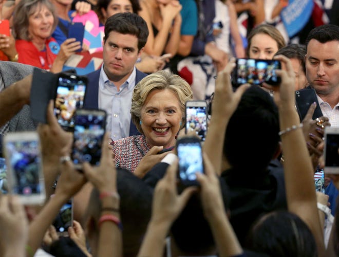 Democratic presidential candidate Hillary Clinton poses for photos after speaking at a rally at Miami Dade College in Miami, Tuesday, Oct. 11, 2016. (Mike Stocker/South Florida Sun-Sentinel via AP)