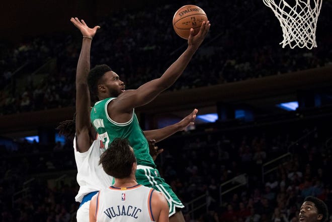 Boston Celtics forward Jaylen Brown goes to the basket past New York Knicks forward Maurice Daly Ndour, left, and guard Sasha Vujacic during the second half of a preseason NBA basketball game, Saturday, Oct. 15, 2016, at Madison Square Garden in New York.