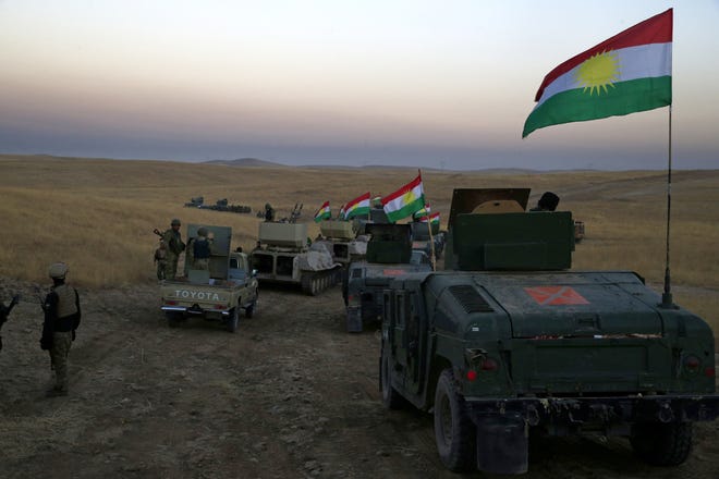 A Peshmerga convoy drives towards a frontline in Khazer, about 19 miles east of Mosul, Iraq, Monday, Oct. 17, 2016. (AP Photo/Bram Janssen)
