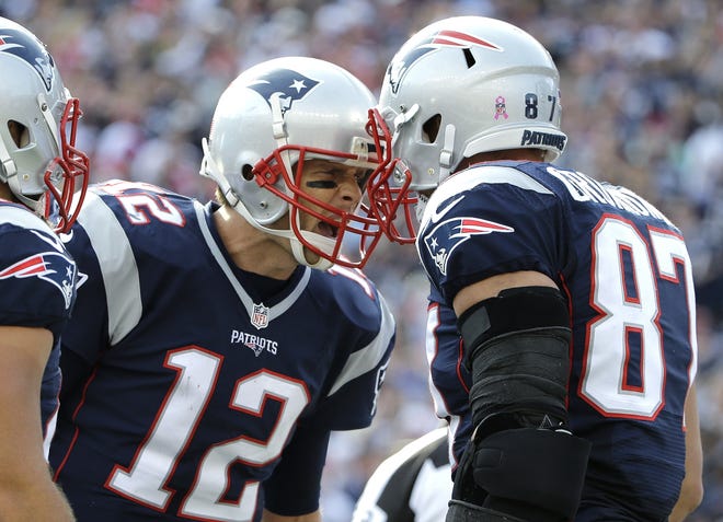 Tom Brady celebrates his touchdown pass to tight end Rob Gronkowski (87) during the second half of Sunday's home game against the Cincinnati Bengals. Gronkowski caught seven passes for a career-high 162 yards. AP Photo