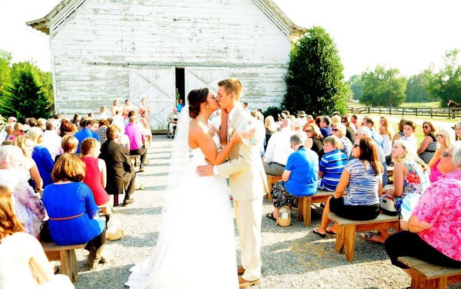 Aerial and Dylan Burleson kiss after being married at Lewis Farm. Photos courtesy of Lewis Farm.