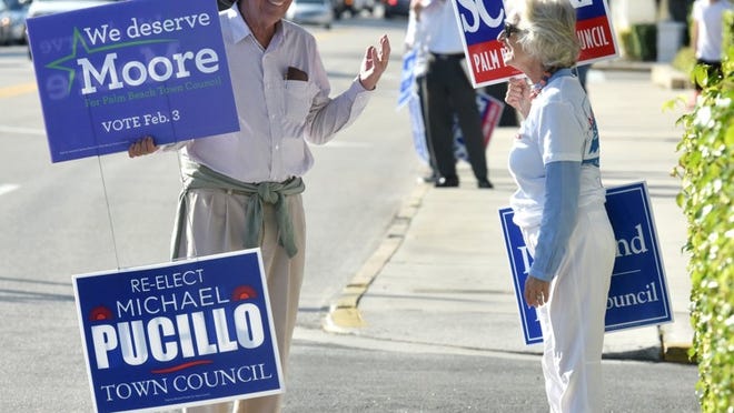 Tanner Rose and Anne Pepper have a friendly conversation while holding opposing signs in 2015 on Election Day.