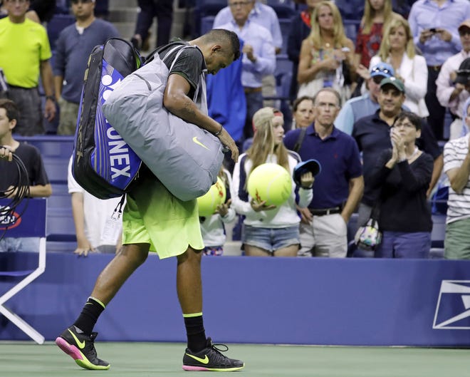 In this Saturday, Sept. 3, 2016 file photo Nick Kyrgios, of Australia, leaves the court after retiring from a match against Illya Marchenko, of Ukraine, during the U.S. Open tennis tournament, in New York. The ATP has suspended Nick Kyrgios for at least 3 weeks and fined him extra $25,000 for conduct contrary to 'integrity' of tennis. THE ASSOCIATED PRESS / JULIO CORTEZ