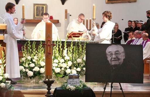 Priests attend a mourning Mass t for Poland's leading filmmaker Andrzej Wajda , at the Dominican friars' church in Warsaw, Poland, Tuesday, Oct. 18, 2016. Wajda died in hospital on Oct. 9, at the age of 90. He is to be buried in a private funeral ceremony Wednesday in the southern city of Krakow. (AP Photo/Czarek Sokolowski)