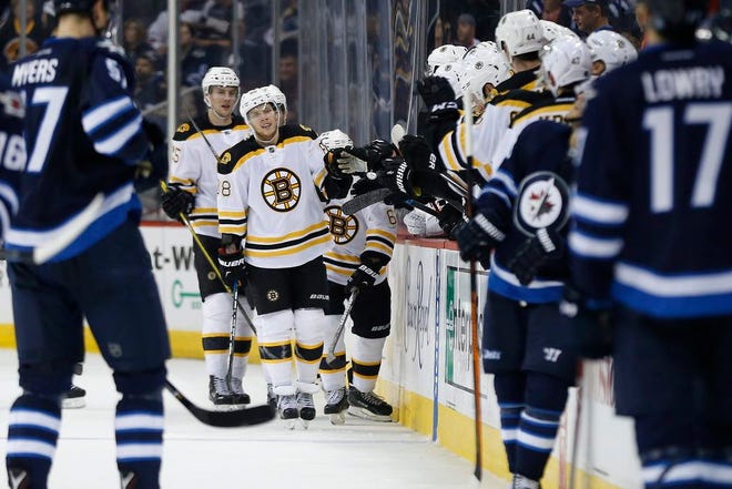 Boston Bruins' David Pastrnak, center, celebrates his goal against Winnipeg Jets during second period NHL hockey action in Winnipeg, Manitoba, Monday, Oct. 17, 2016.