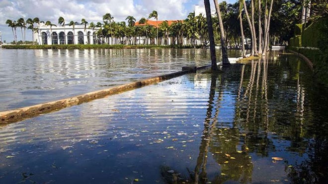 There’s water on both sides of the seawall looking toward the Flagler Museum along Lake Trail in Palm Beach over an hour after high tide Monday morning. (Lannis Waters / The Palm Beach Post)
