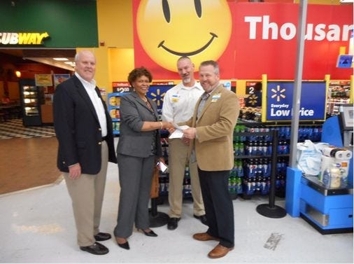 Crisis Assistance Response Emergency Shelter (CARES) received a donation from the Walmart Foundation during a check presentation ceremony at the Walmart Supercenter in Petersburg on Monday. Pictured from left to right are: George Joyner, Walmart market manager; Dr. Cheryl Riggins, executive director of CARES; Lee Swegle, Walmart store manager; and Jade White, Walmart market manager. Contributed Photo