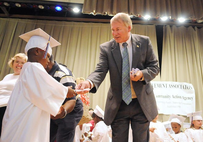 In this 2011 file photo, W. David Clark, superintendent of Dinwiddie County Public Schools, hands out diplomas during a Dinwiddie Elementary School Improvement Association Head Start graduation ceremony. Clark recently announced his retirement from the school system. Patrick Kane, File/progress-index.com