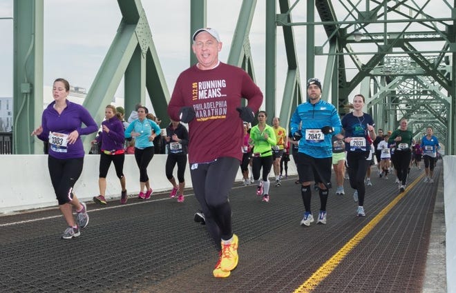 (FILE) Runners of the 2012 Trenton Double Cross Half Marathon stride over the Trenton "Makes" Bridge. The route offers runners the somewhat unique opportunity to cross the mighty Delaware River not once, but twice.