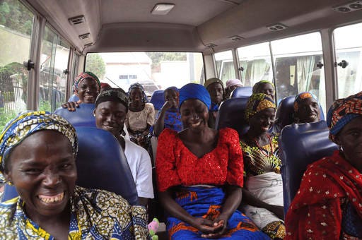 Family members of the Nigerian Chibok kidnapped girls share a moment as they depart to the Nigerian minister of women affairs in Abuja, Nigeria, Tuesday, Oct. 18, 2016. Nigeria's government is negotiating the release of another 83 of the Chibok schoolgirls taken in a mass abduction two-and-a-half years ago, but more than 100 others appear unwilling to leave their Boko Haram Islamic extremist captors, a community leader said Tuesday.(AP Photo/Olamikan Gbemiga)