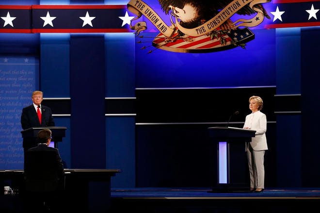 Moderator Chris Wallace, center, speaks as Donald Trump and Hillary Clinton listen during the third U.S. presidential debate in Las Vegas on Wednesday.