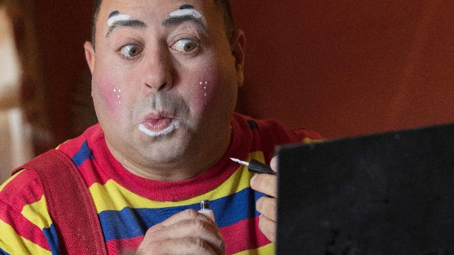 Cyrus Zaveih, also known as Cido the Clown, applies his make-up, Tuesday, Oct. 18, 2016. A spate of scares involving people doing menacing things while dressed in clown costumes has been no laughing matter for real clowns. Some clowns who perform at parties and other private events complain that bookings have fallen off amid creepy clown sightings, some of which have been revealed to be hoaxes. (AP Photo/Mary Altaffer)