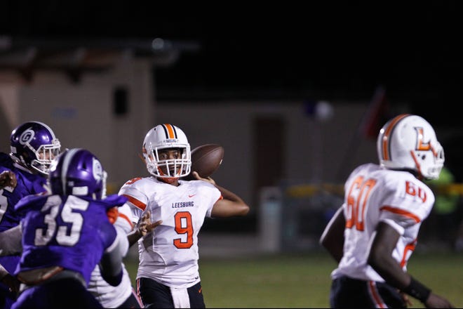Leesburg quarterback A.J. Graham looks to throw a pass during a game against Gainesville High in Gainesville on Thursday night. Gainesville defeated Leesburg 38-12. (Chris Totzke/ Gatehouse Media)