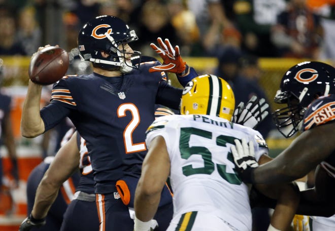 Chicago's Brian Hoyer (2) throws under pressure by Green Bay's Nick Perry during the first half Thursday in Green Bay, Wisconsin. ASSOCIATED PRESS/MIKE ROEMER