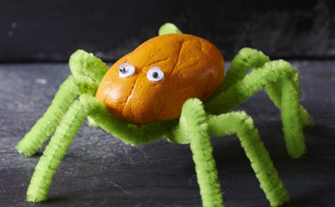 Making spiders out of rocks and pipe cleaners is a fun craft for a kids Halloween party. FAMILYFUN MAGAZINE
