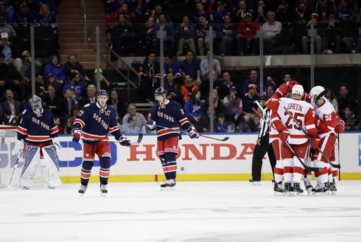 The Detroit Red Wings celebrate a goal by Thomas Vanek during the second period of an NHL hockey game as New York Rangers goalie Henrik Lundqvist, left, stands in front of the goal Wednesday, Oct. 19, 2016, in New York. (AP Photo/Frank Franklin II)