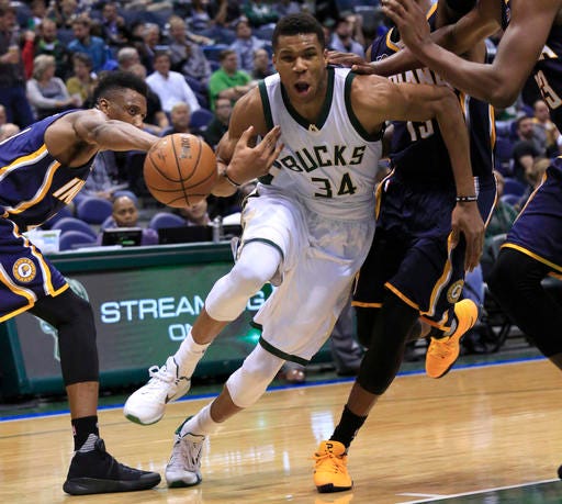 Milwaukee Bucks forward Giannis Antetokounmpo, center, loses the ball on a drive against the Indiana Pacers during the second half of an NBA preseason basketball game Wednesday, Oct. 19, 2016, in Milwaukee. (AP Photo/Darren Hauck)