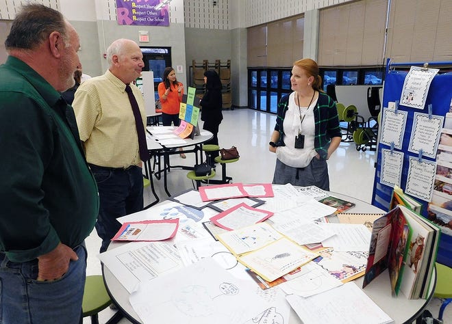 Herkimer Elementary School teacher Jennifer Olds, pictured on right, talks with school board members Mark Conley, far left, and Robert Mihevc during a school board meeting at the elementary school on Wednesday. Several teachers with the Curriculum Council made presentations during the meeting for board members and others to learn more about what they are doing. TIMES TELEGRAM PHOTO/STEPHANIE SORRELL-WHITE