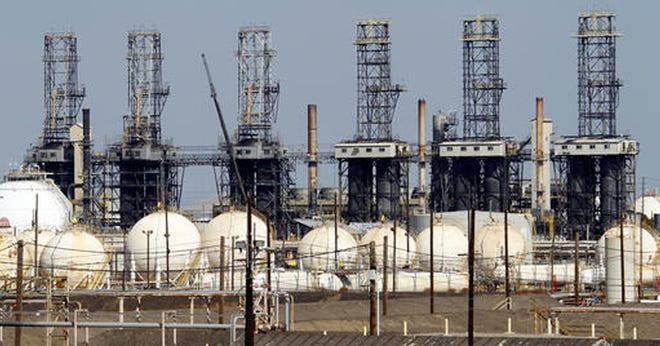 In this Oct. 8, 2012, file photo, the ExxonMobil refinery in Torrance, Calif., is seen. (AP Photo/Reed Saxon, File)