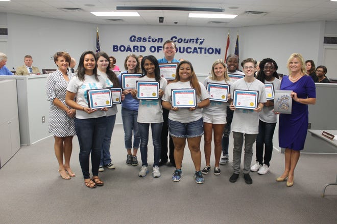 The Gaston County Board of Education recently presented certificates to the Early College yearbook staff in recognition of their award. From left , are board member Catherine Roberts with students Yuliana Melendez, Kaycee Reagan, Alexis Jones and Talyah Regusters, teacher and yearbook adviser Russ Paul, Alyssa Smock, Kayla McGill, Aniyah Curry, Gracie Edwards, Lizzy Tetteh-Ocloo, and Early College Principal Sheila Wyont.