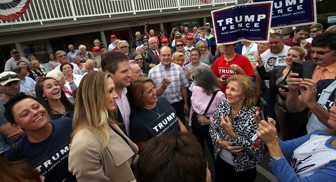 The Trump Train made a stop at the GOP Headquarters on Garrison Boulevard in Gastonia Friday morning bringing Donald Trump's son Eric Trump and his wife Lara to town. Here, the two are surrounded by Trump supporters after they arrive. PHOTO MIKE HENSDILL/THE GAZETTE