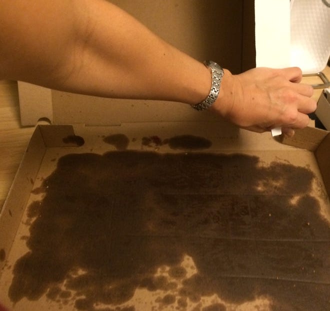A pizza box that's a little greasy is fine to recycle, but if it's soaked with oil like this one, the best you can hope for is that the lid is clean enough for the bin. Courtesy of RIRRC