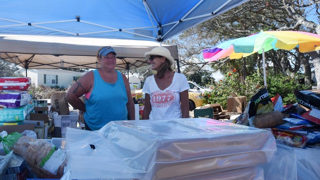 christina.kelso@staugustine.com — Eve Dreyer, left, and Pam Davidson collect and distribute food, clothing, cleaning and hygiene supplies at the intersection of Treasure Beach Road and Costanero Road on Thursday October 20, 2016. Both have spent every day since returning to the island among volunteers working in the donation station, which started with just a few supplies Dreyer set out on a table to tents amassing enough to supply eight neighborhoods.