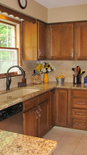 New granite countertops and a tile backsplash add warm color to a former vanilla kitchen at the Parker household. PAM PARKER/ERIE TIMES-NEWS