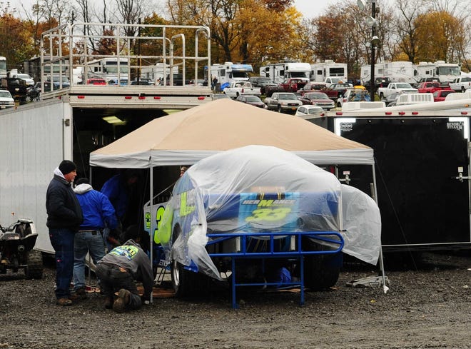 John Lieto's big block modified team scrambles to try and work on their car as rain postponed all of the 55th annual Eastern States Weekend Racing Festival races on Saturday at the Orange County Fair Speedway in Middletown. Bob Armbruster/Photo provided