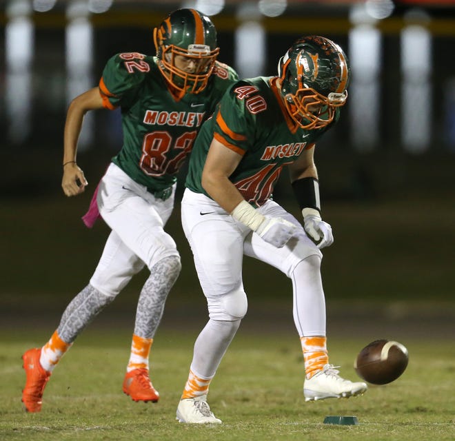 Mosley's Geoffrey Lancaster executes an onside kick which he later recovered in the second quarter of the Dolphins' 31-30 win over Pensacola on Friday night. Patti Blake/ The News Herald