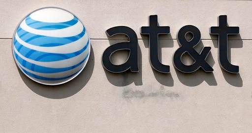 FILE - This May 14, 2014 file photo shows an AT&T logo on a store in Dedham, Mass. On Saturday, Oct. 22, 2016, several reports citing unnamed sources said the giant phone company is in advanced talks to buy Time Warner, owner of the Warner Bros. movie studio as well as HBO and CNN. AT&T is said to be offering $80 billion or more, a massive deal that would shake up the media landscape. (AP Photo/Steven Senne, File)