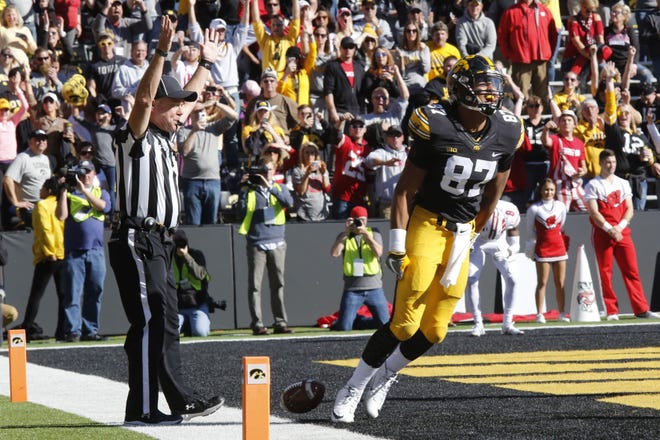 Noah Fant throws down the football while celebrating a touchdown against Wisconsin Saturday at Kinnick Stadium in Iowa City. The Badgers won the game, 17-9.