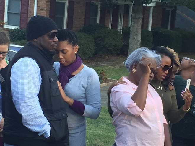 Family members of Jacobia Lane grieve at a vigil put on by her family in Gastonia Sunday. Lane was killed when bullets struck Tim English's Nottingham Drive house in the early hours of Saturday. ADAM LAWSON/THE GAZETTE