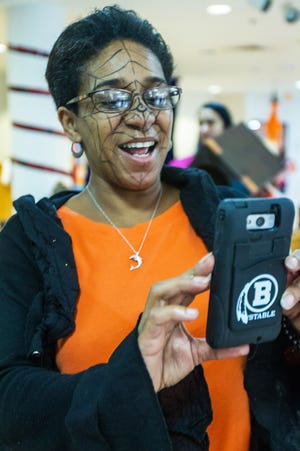 Maria Reid of Hyannis takes photographs at Barnstable Recreation's and the FUN program of Cape Cod Child Development's Not-So-Scary Halloween event at Barnstable Intermediate school Saturday, Oct. 22, 2016. Lots of activities, including witch hat ring toss, scarecrow toss, craft activities, a graveyard trick or treat egg hunt, and magic show kept young and old entertained. PHOTO BY VINCENT DEWITT