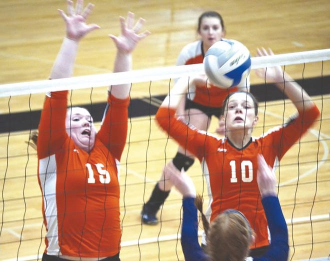 Cheboygan juniors Leah Charboneau (15) and Addie Budzinski (10) go up for a block during a match against Sault Ste. Marie on Monday.