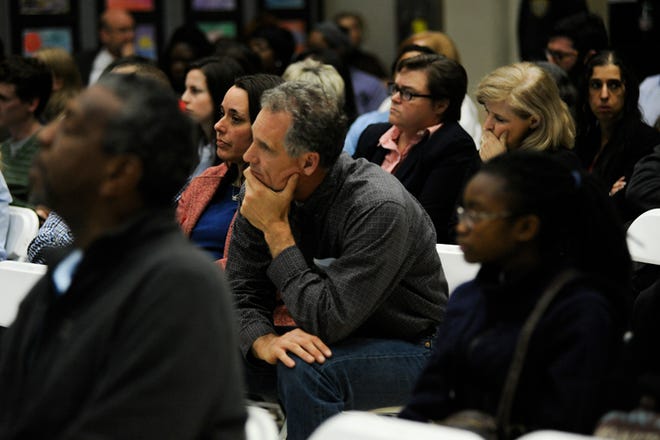Attendees listen and react while a community speaker discusses the alleged rape that occurred at Cedar Shoals High School during the Clarke County School District Board of Education meeting on Thursday, Feb. 11, 2016, in Athens, Ga. (Staff File Photo)