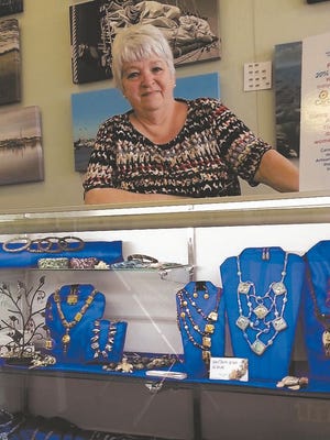 Joan Bomhard, owner of Artisan Gallery in Emerald Isle, is offering free space in her gallery next month as a way to help vendors who lost expenses due to the cancellation of the Swansboro Mullet Festival. Photo by Jannette Pippin/The Daily News