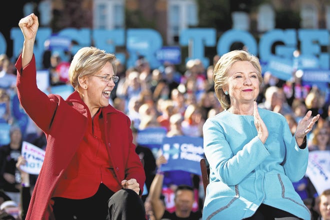 Andrew Harnik/AP U.S. Sen. Elizabeth Warren, D-Mass., joins Democratic presidential candidate Hillary Clinton at a rally Monday at St. Anselm College in Manchester, N.H.